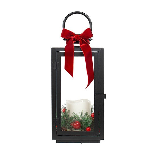 Small black Christmas LED lantern with red velvet ribbon, white candle, festive pine greenery and red berries