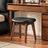 Norman black upholstered walnut dressing stool styled beneath a matching solid wood vanity table
