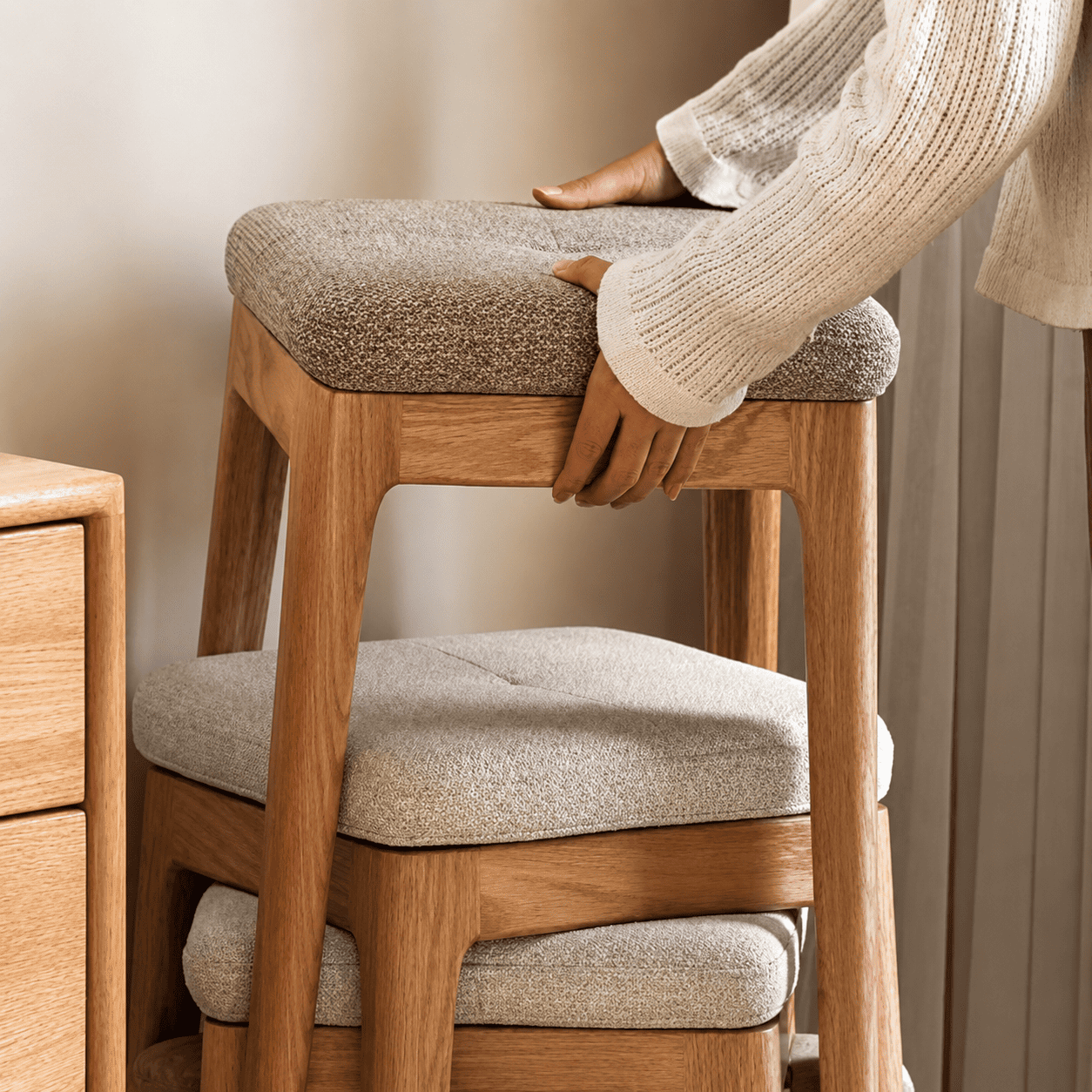 Light oak nesting stools with cushioned fabric seats for compact and versatile seating
