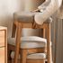 Light oak nesting stools with cushioned fabric seats for compact and versatile seating