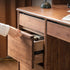 Oliveri solid walnut desk with hutch, drawers, pegboard and glass cabinet in a home office setting