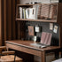 Oliveri solid walnut desk with hutch, drawers, pegboard and glass cabinet in a home office setting