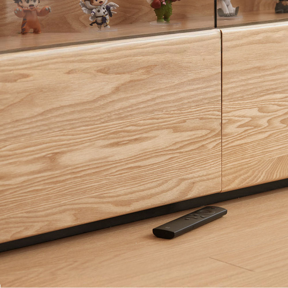 Osini natural solid ash entertainment unit with grey glass display shelf, built-in LED lighting and multiple drawers, styled as a modern floating TV cabinet.