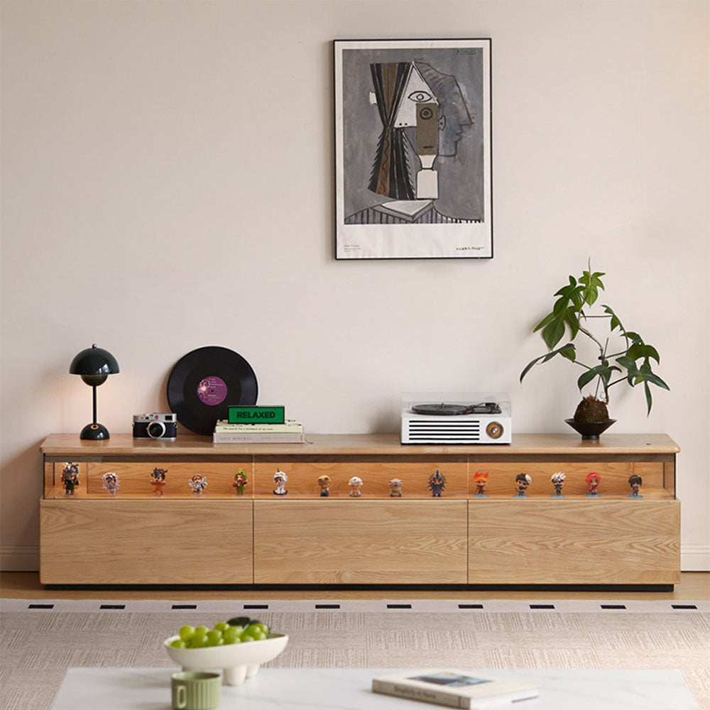 Osini natural solid ash entertainment unit with grey glass display shelf, built-in LED lighting and multiple drawers, styled as a modern floating TV cabinet.