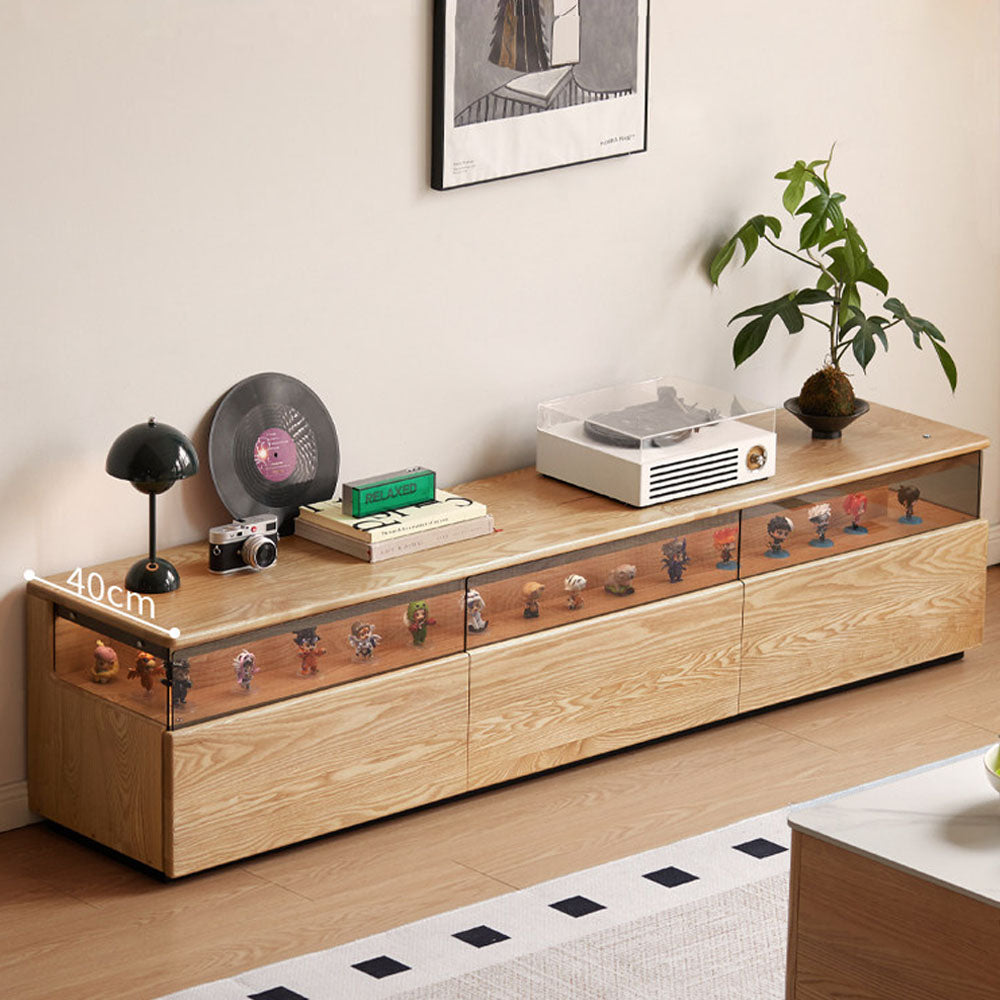 Osini natural solid ash entertainment unit with grey glass display shelf, built-in LED lighting and multiple drawers, styled as a modern floating TV cabinet.