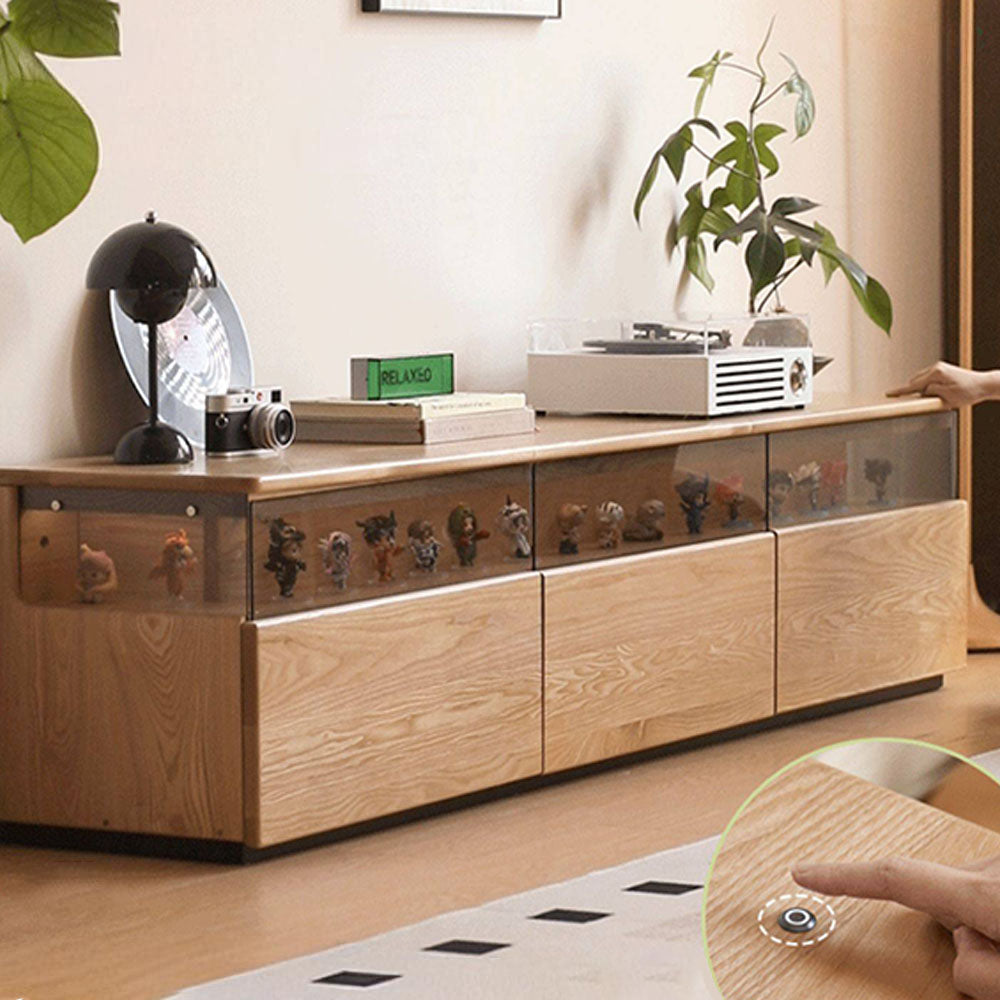 Osini natural solid ash entertainment unit with grey glass display shelf, built-in LED lighting and multiple drawers, styled as a modern floating TV cabinet.