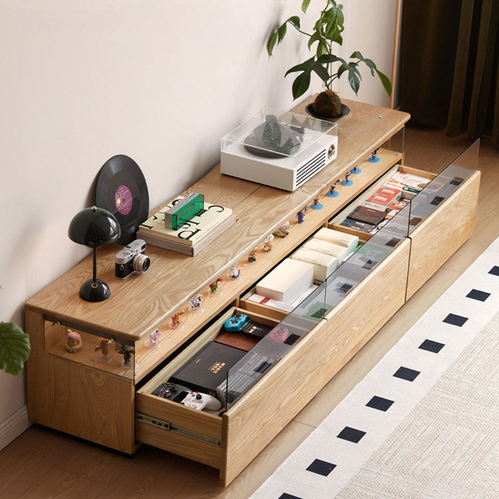 Osini natural solid ash entertainment unit with grey glass display shelf, built-in LED lighting and multiple drawers, styled as a modern floating TV cabinet.