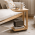 Scandinavian-style oak sofa side table with a lower shelf and smooth-rolling casters