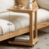 Modern wooden C-shaped side table with caster wheels and a lower storage shelf