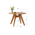 Natural solid cherry small round dining table in a warm timber finish, shown in a compact dining space with dining chairs and kitchen backdrop