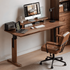 Prunus natural solid walnut electric height adjustable computer desk styled in a warm home office with monitor and office chair
