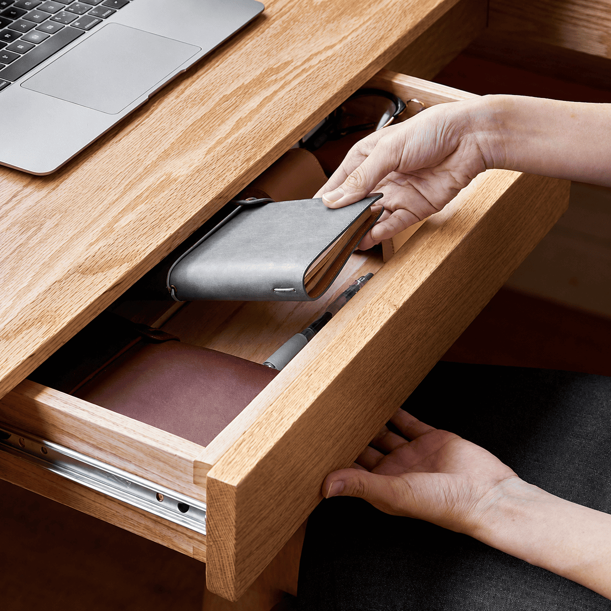 Minimalist oak L-shaped home office desk with an open-frame design and expansive work surface