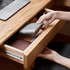 Minimalist oak L-shaped home office desk with an open-frame design and expansive work surface