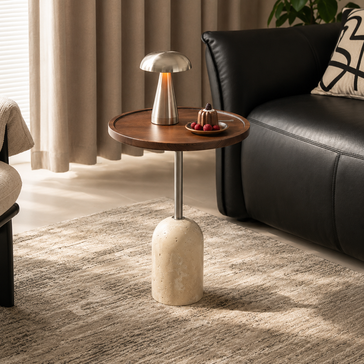 Front view of a round walnut side table with slim metal stem and cylindrical travertine base.
