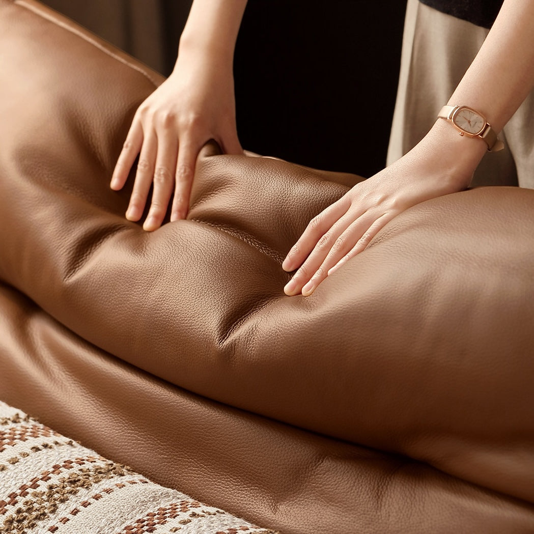 Close-up of Tacoma leather sofa cushion showing soft padded genuine leather texture