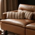 Tacoma leather sofa detail with brown striped lumbar cushions and plush seat padding