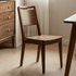 Truro Natural Solid Walnut Dining Chair styled with walnut dining table in a warm dining room