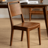Natural solid walnut dining chair with curved wooden seat and slim timber backrest