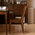 Solid walnut dining chair with smooth rounded seat for modern dining room styling
