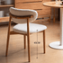 Visby Natural Solid Oak Dining Chair with white boucle seat, curved backrest, and 45cm seat height