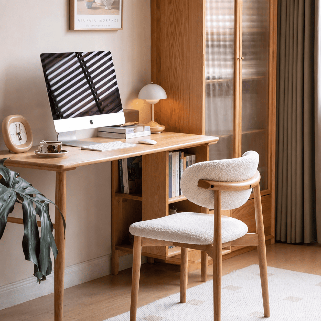 Visby Natural Solid Oak Dining Chair styled at a home office desk with white boucle upholstery and natural oak frame