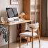 Visby Natural Solid Oak Dining Chair styled at a home office desk with white boucle upholstery and natural oak frame