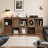Three-section walnut sideboard with open storage and sliding wood panels used as a home coffee station.