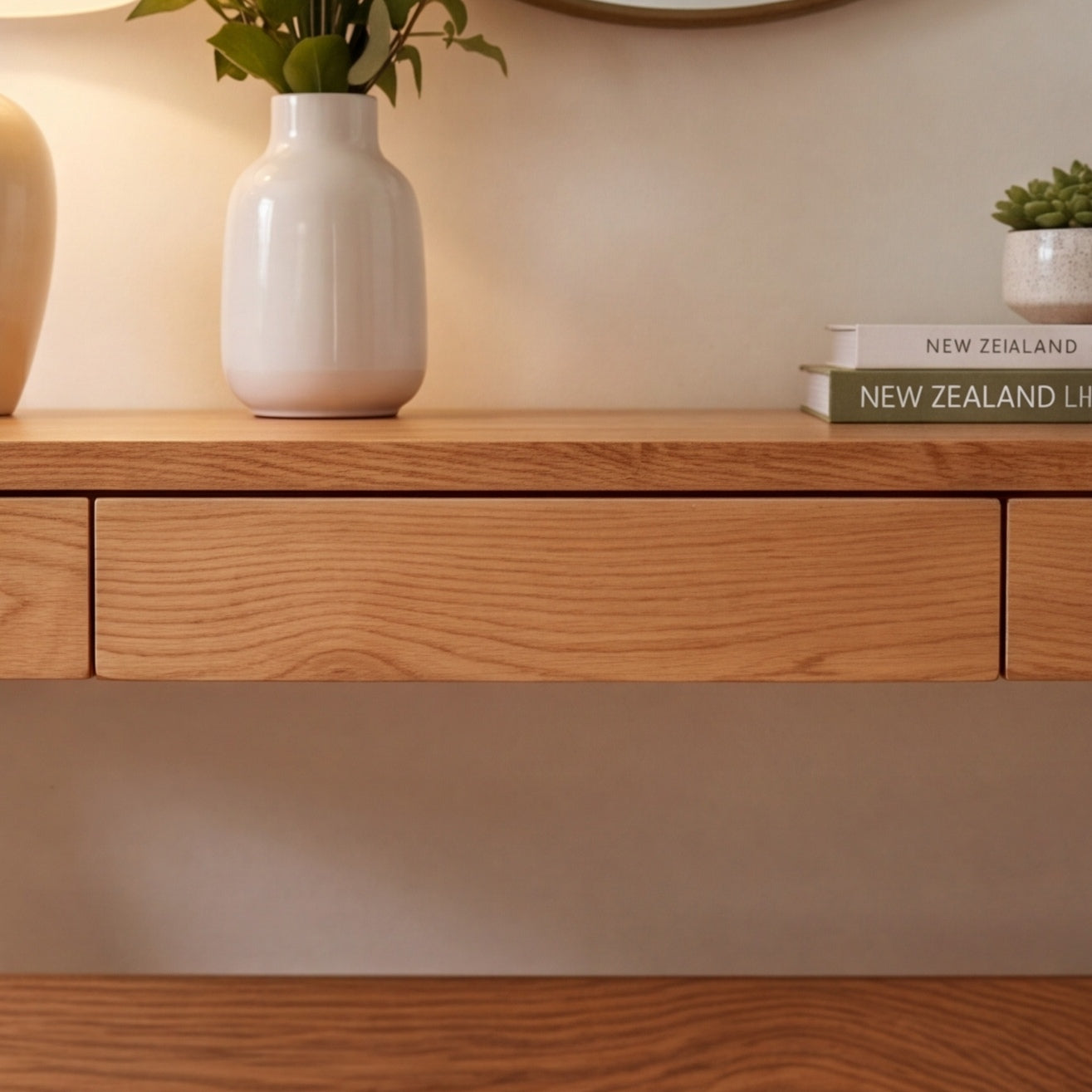 Natural solid oak console table paired with round wall mirror for stylish hallway décor