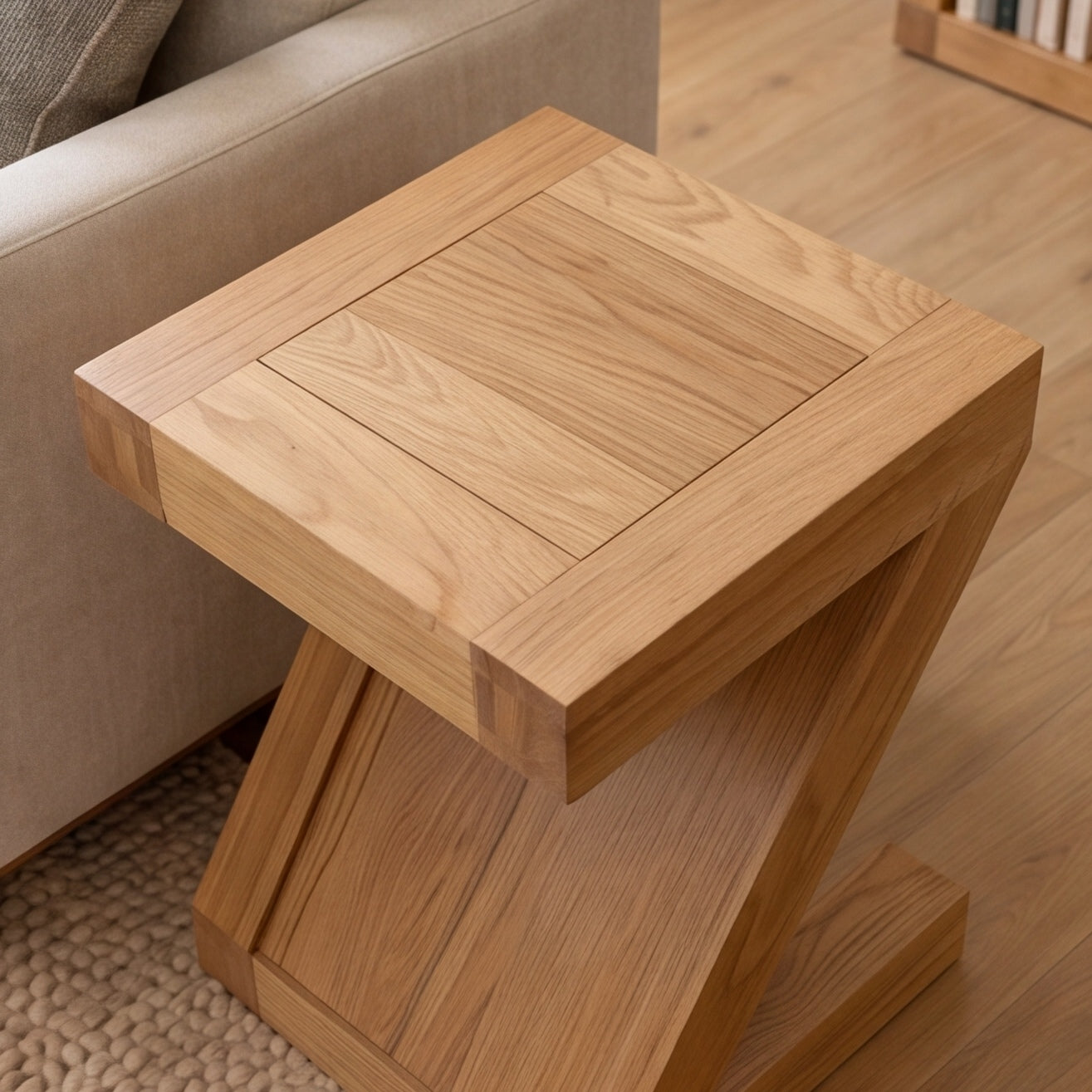 Solid oak side table styled with table lamp, coffee mug, and open magazine