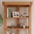 Natural oak open bookshelf for displaying books, baskets, plants, and home décor