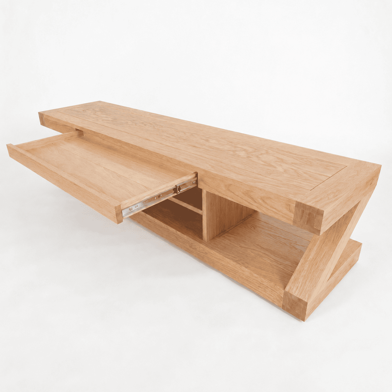 Natural oak TV cabinet styled with books, plant, candle, and home décor accessories